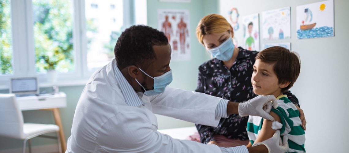 Close up of a pediatrician vaccinating his patient